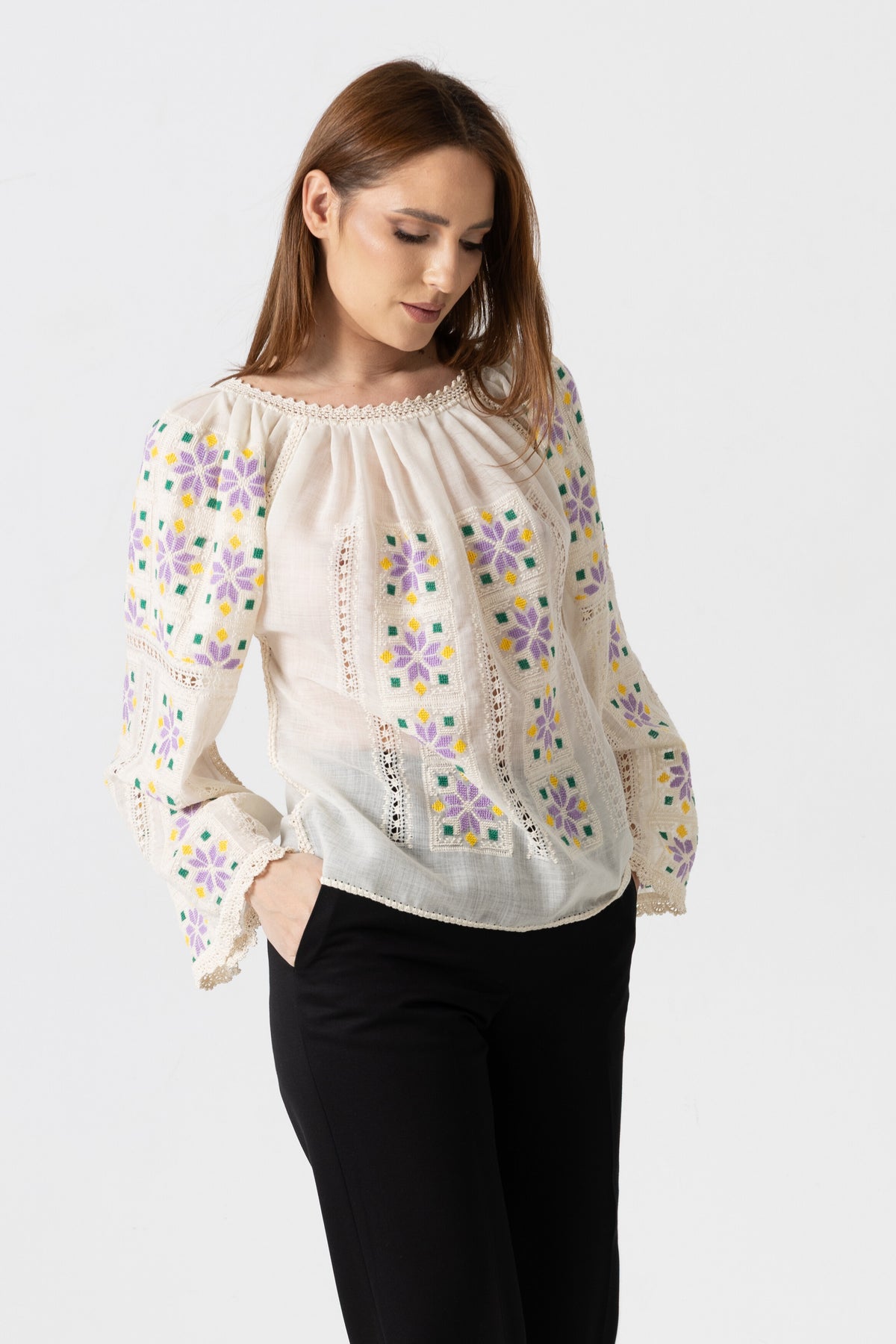 The blouse is hand-sewn on merino wool