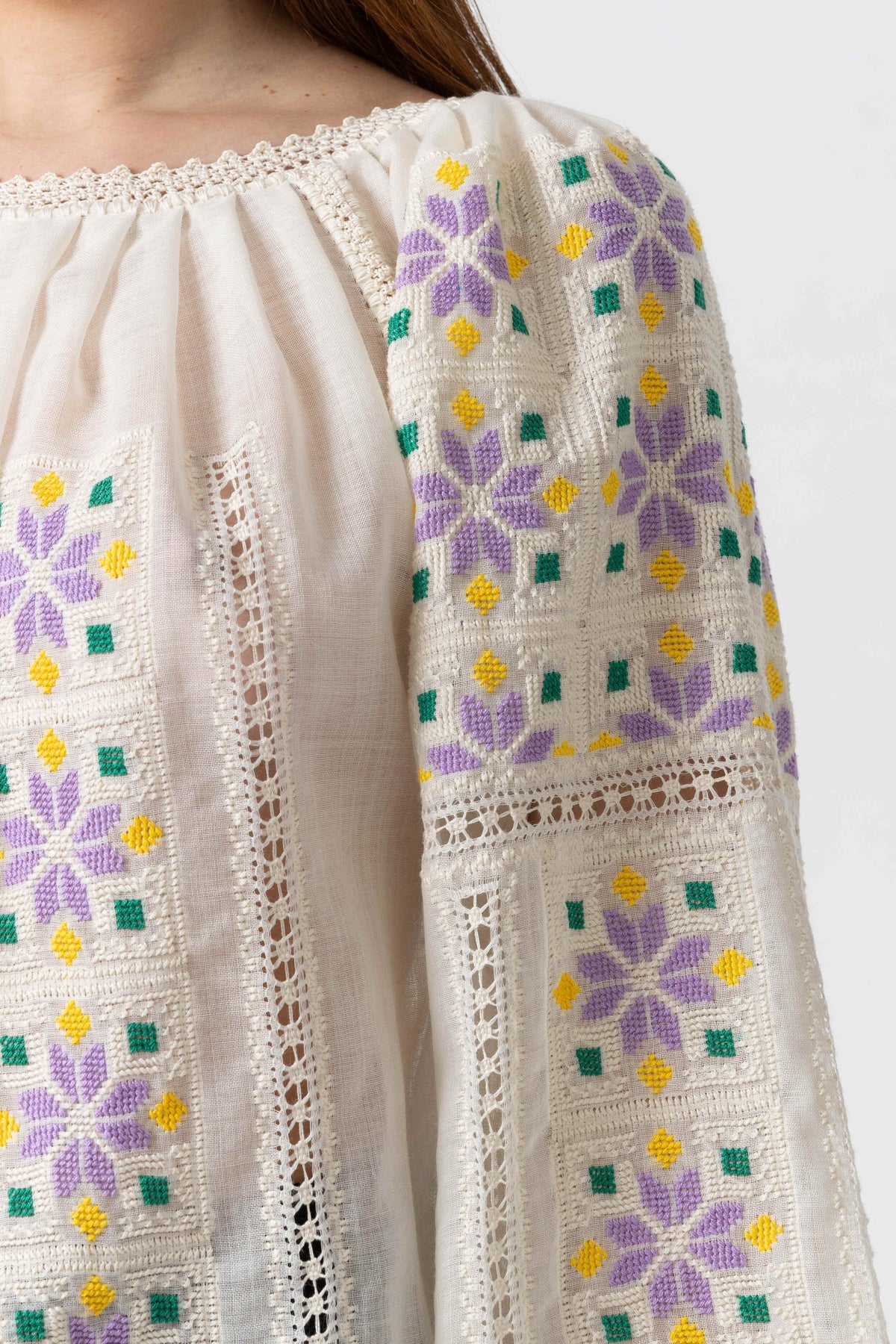 The blouse is hand-sewn on merino wool