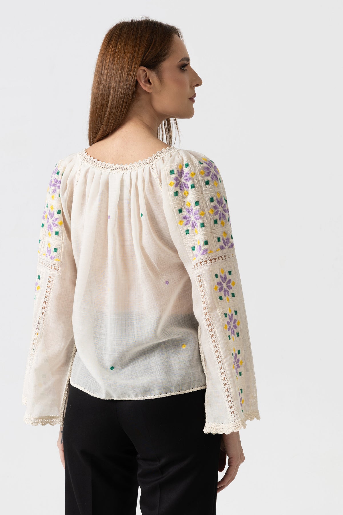 The blouse is hand-sewn on merino wool