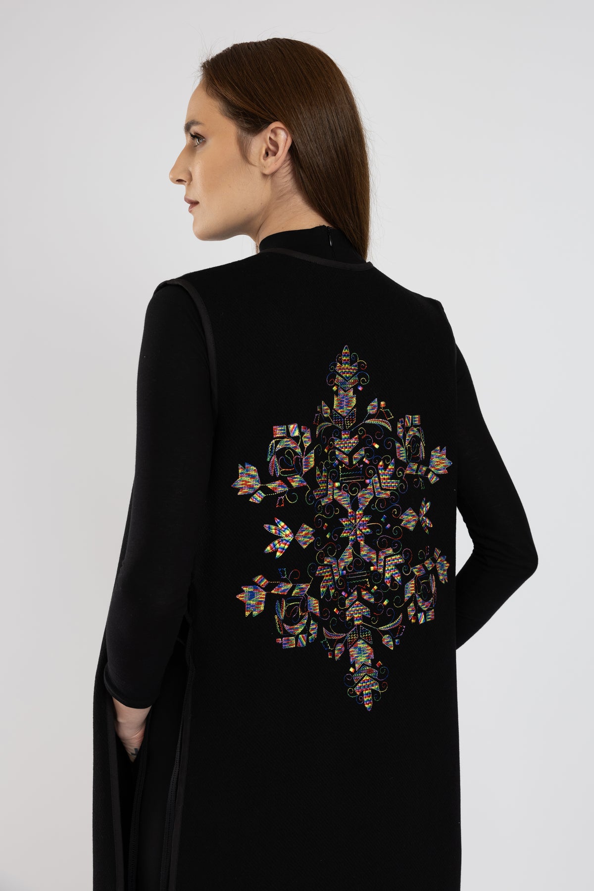 Black woolen midi vest with multicolored floral embroidery and stripes on the side