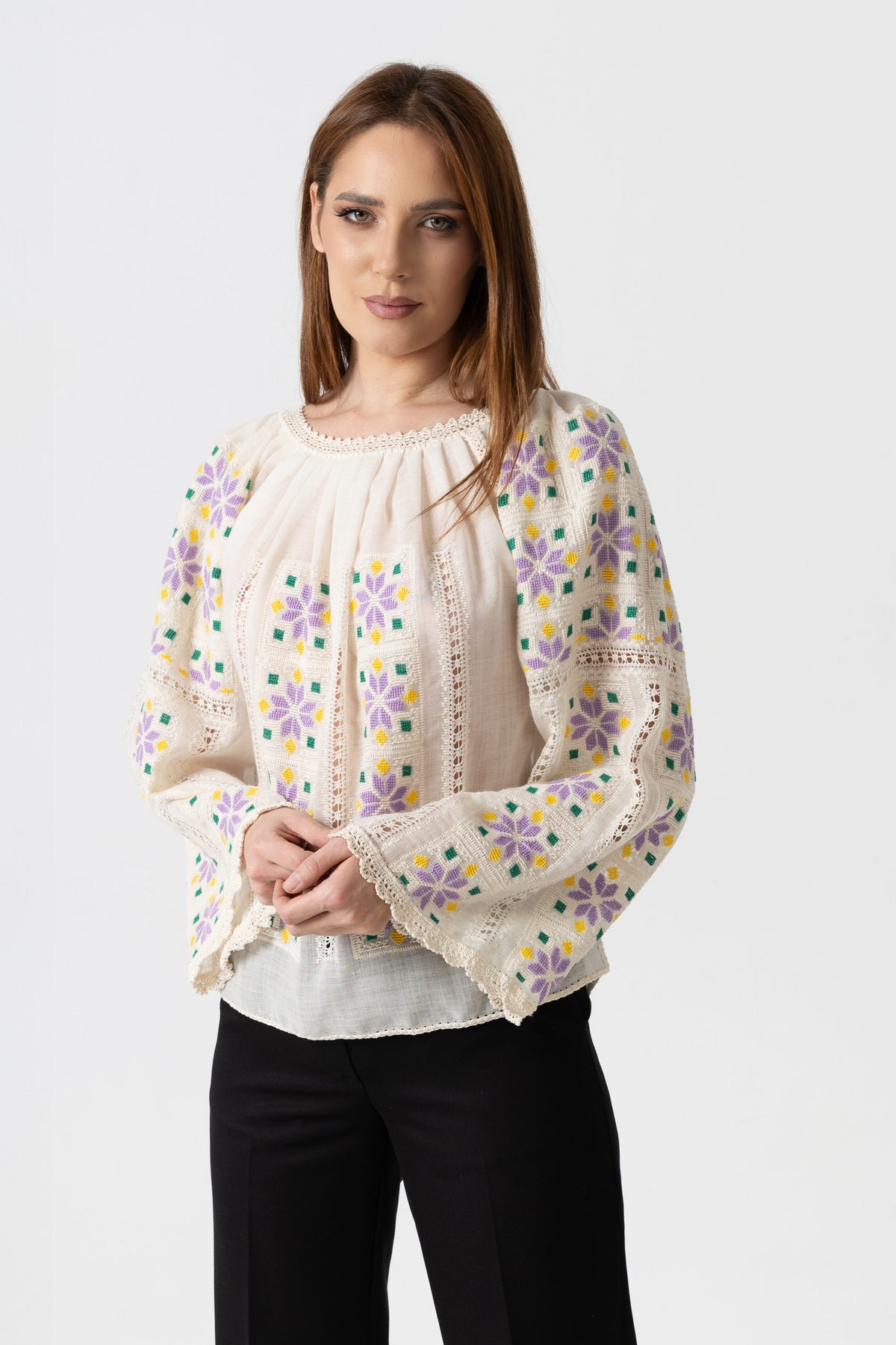 The blouse is hand-sewn on merino wool