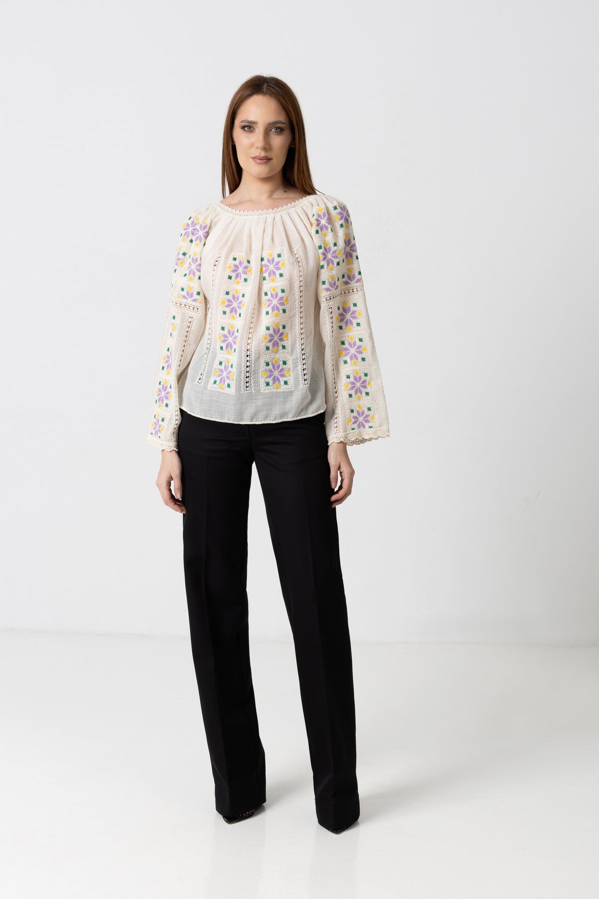 The blouse is hand-sewn on merino wool