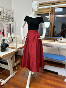 Red midi skirt with pleats and high waist