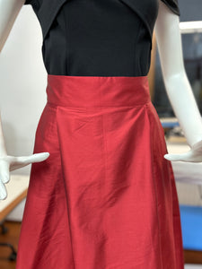 Red midi skirt with pleats and high waist