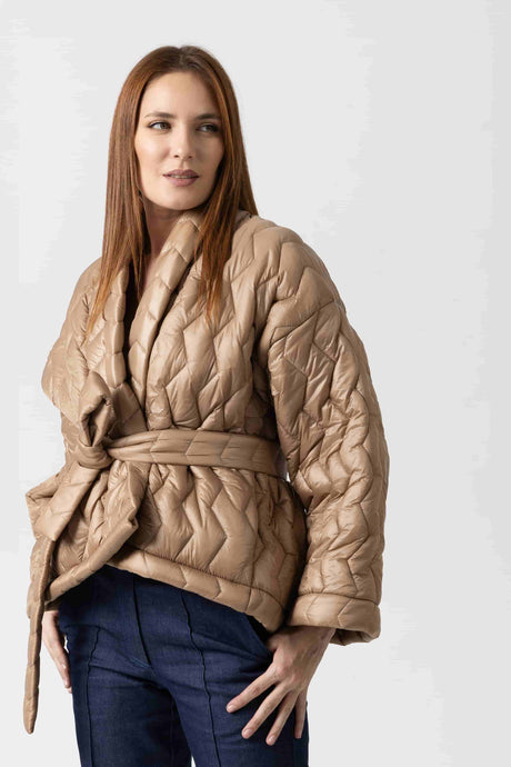 Short asymmetric jacket in navy blue quilted fabric